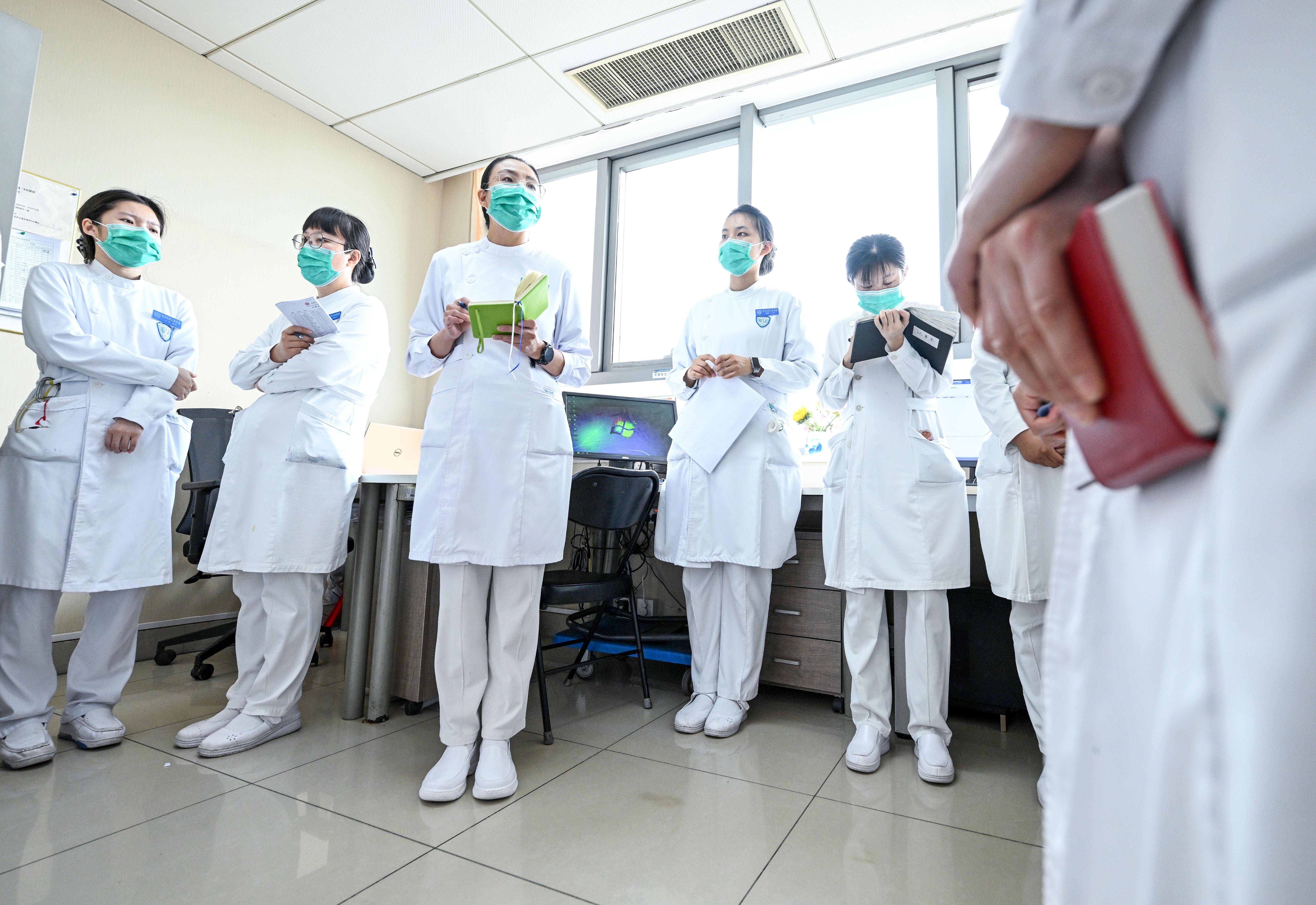 新华社记者 陈晔华 摄5月10日,樊榕榕(左)在骨科护士站巡视科室护理